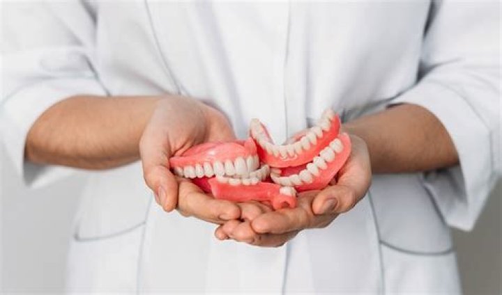 Do permanent dentures hurt?