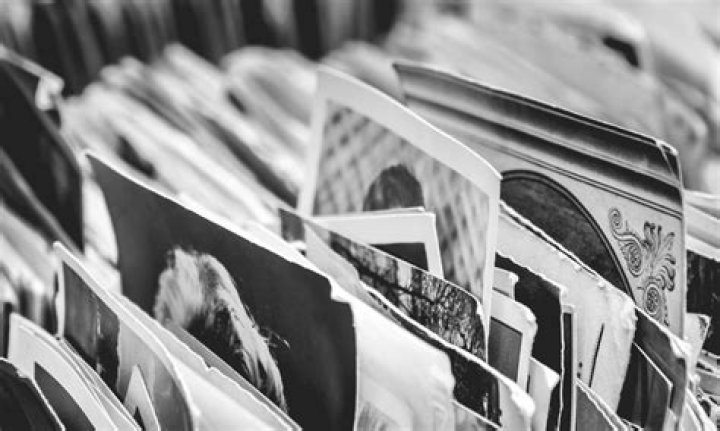 Is it better to scan or photograph old photos?