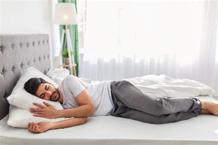 What side of the bed does the man sleep on?