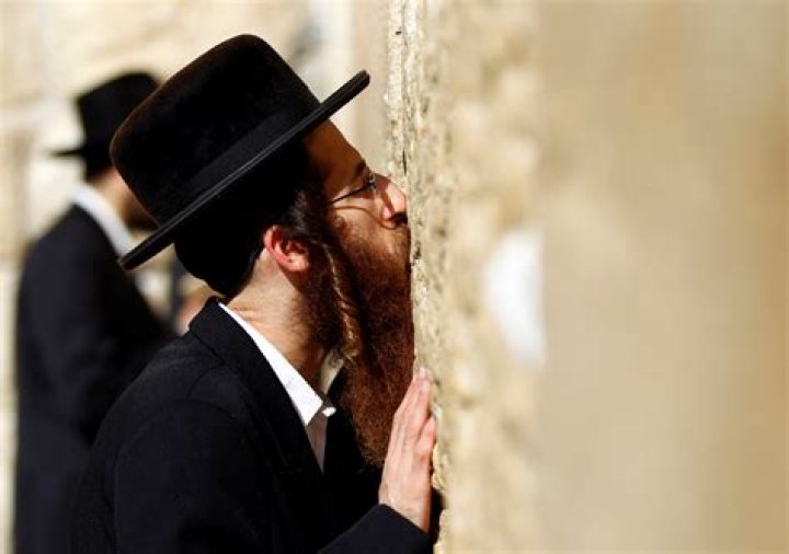 Why do Jews kiss the door?