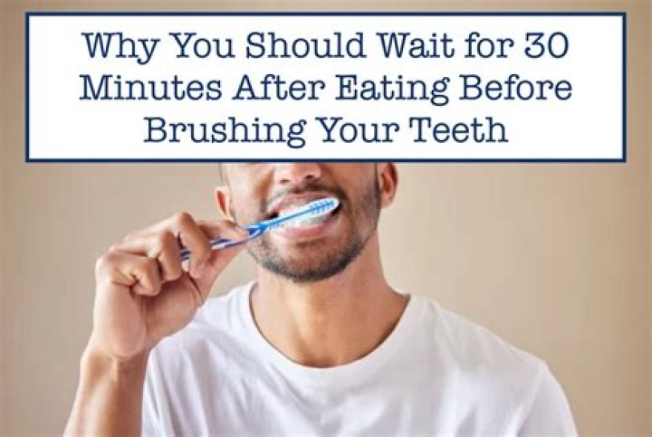 Why should you wait 30 minutes after eating to brush your teeth?